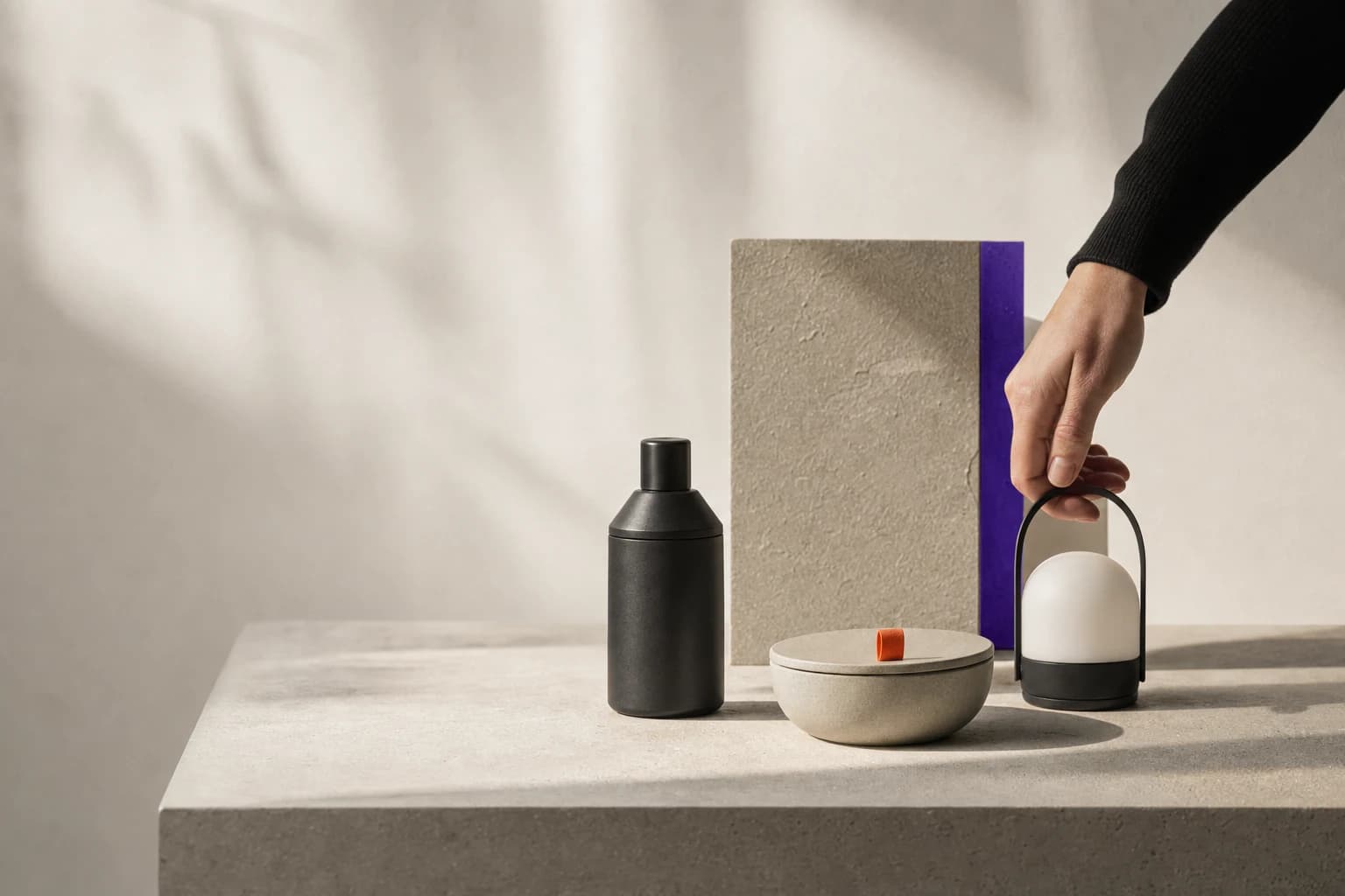 A hand selecting one useful object from a small group of unbranded products.